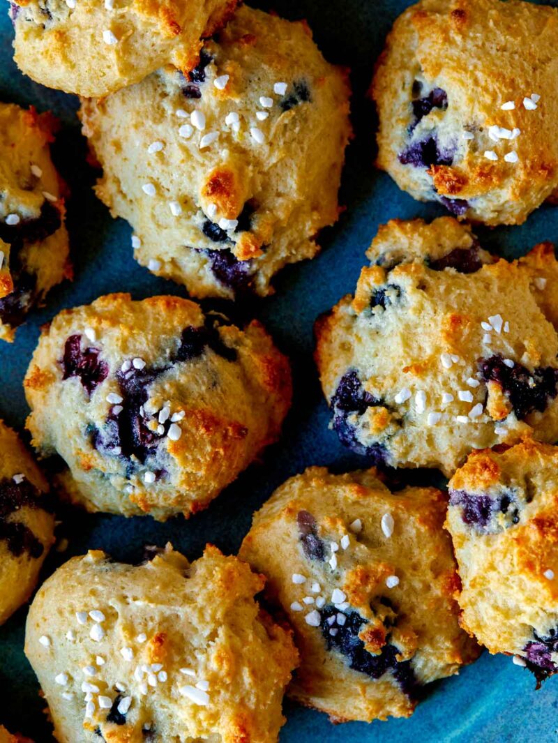 Blueberry Yogurt Cookies with pearl sugar on top close up on a plate.