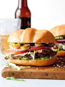 Close up of carne asada torta on a cutting board.