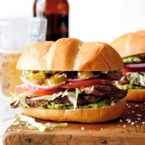 Close up of carne asada torta on a cutting board.