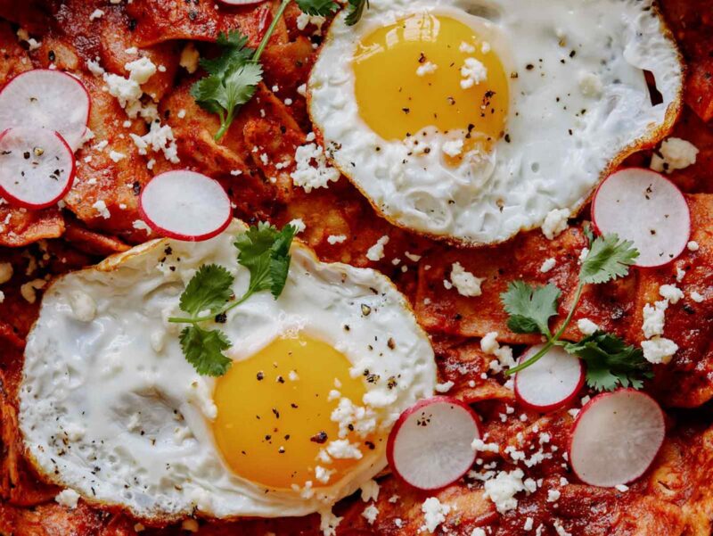 A close up on chilaquiles showing off all the toppings. 