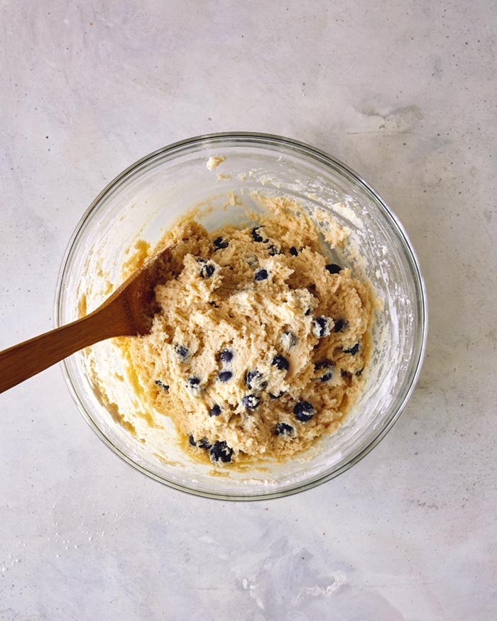 Blueberries combined into a cookie dough batter. 