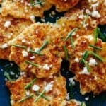 Close up of corn cakes with chives and queso fresco.