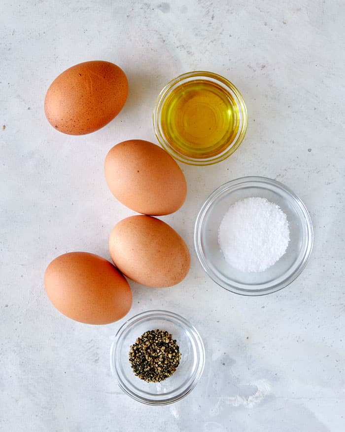 Ingredients to make fried eggs. Eggs, oil, and salt and pepper. 