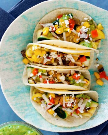 A close up of a plate of grilled zucchini tacos.