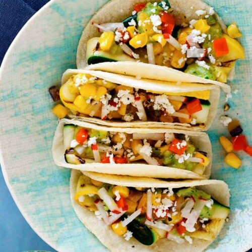 A close up of a plate of grilled zucchini tacos.