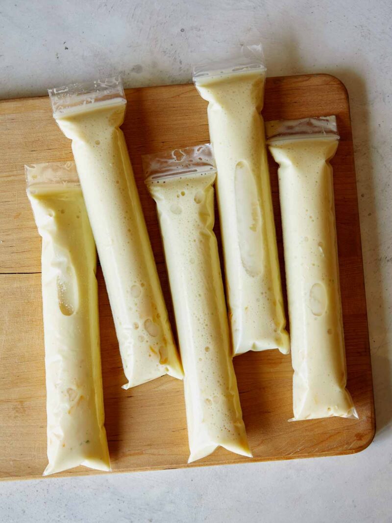 Filled ice pop sleeves with our piña colada recipe ready to be frozen.