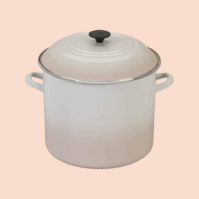 White Le Creuset stockpot with lid on.