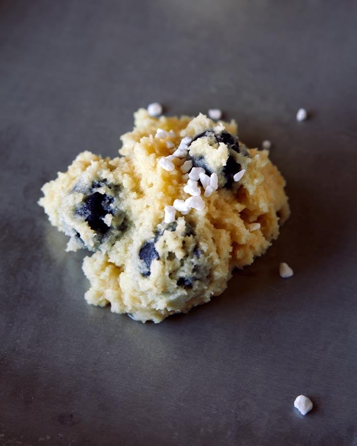 Pearl sugar sprinkled onto an unbaked cookie.