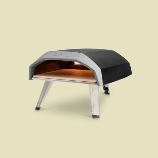A gas powdered Ooni pizza oven on a yellow background.