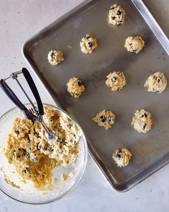 Blueberry yogurt cookies scooped onto a baking sheet. 