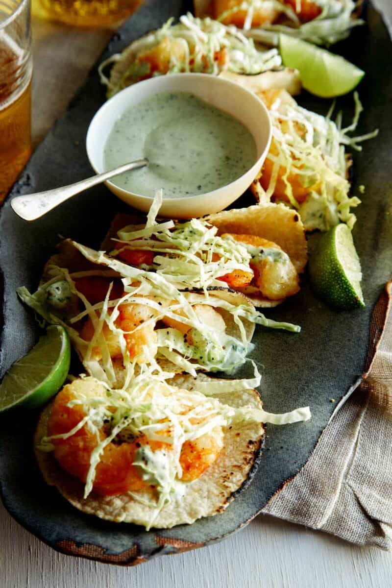 A close up view of the inside of one of the tacos and a beer battered piece of shrimp.