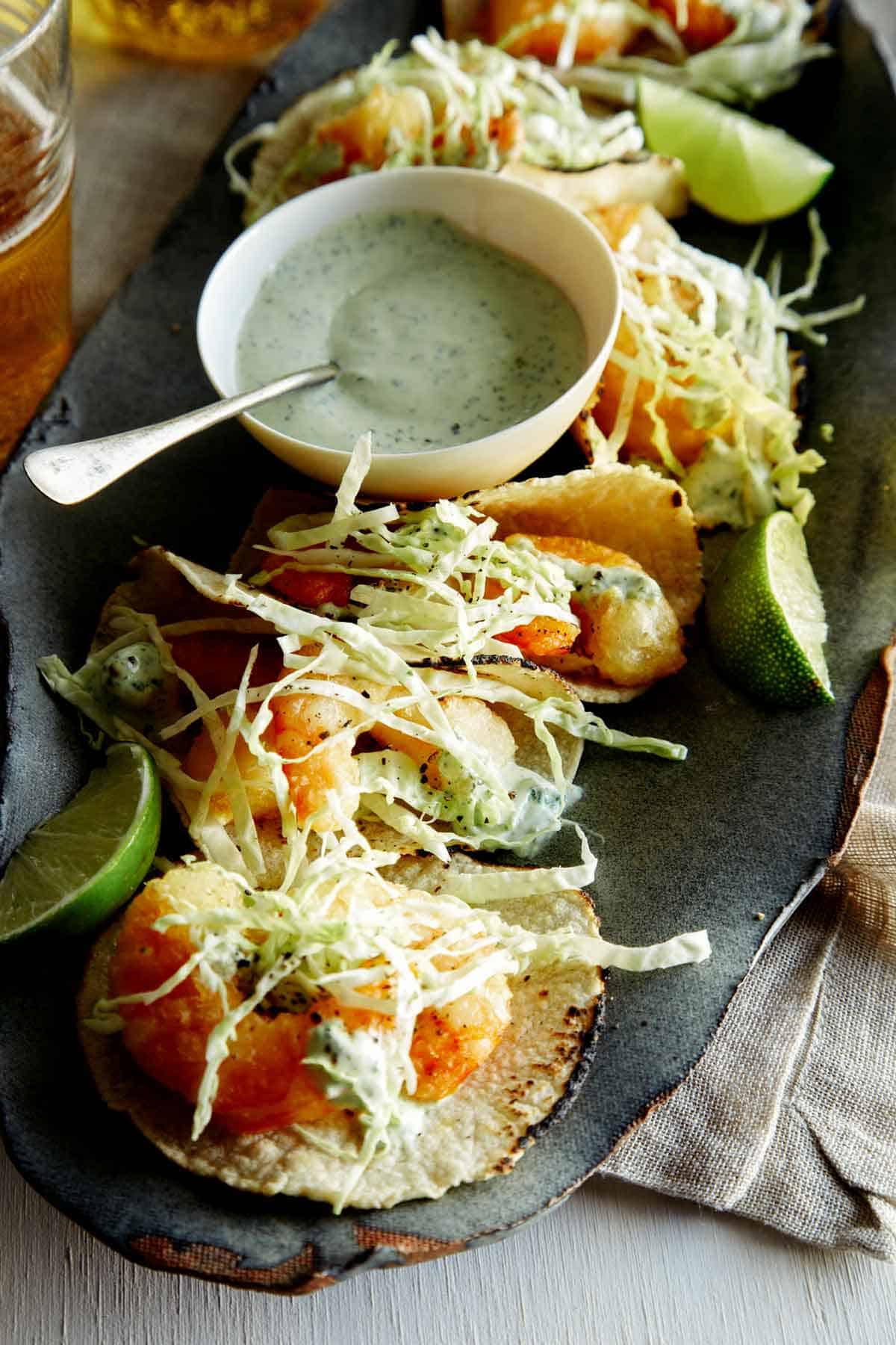 A close up view of the inside of one of the tacos and a beer battered piece of shrimp.