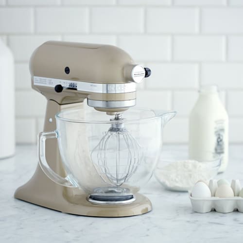 Tan stand up mixer with milk and eggs.