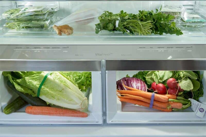 Inside a refrigerator a view of the crisper drawers. 