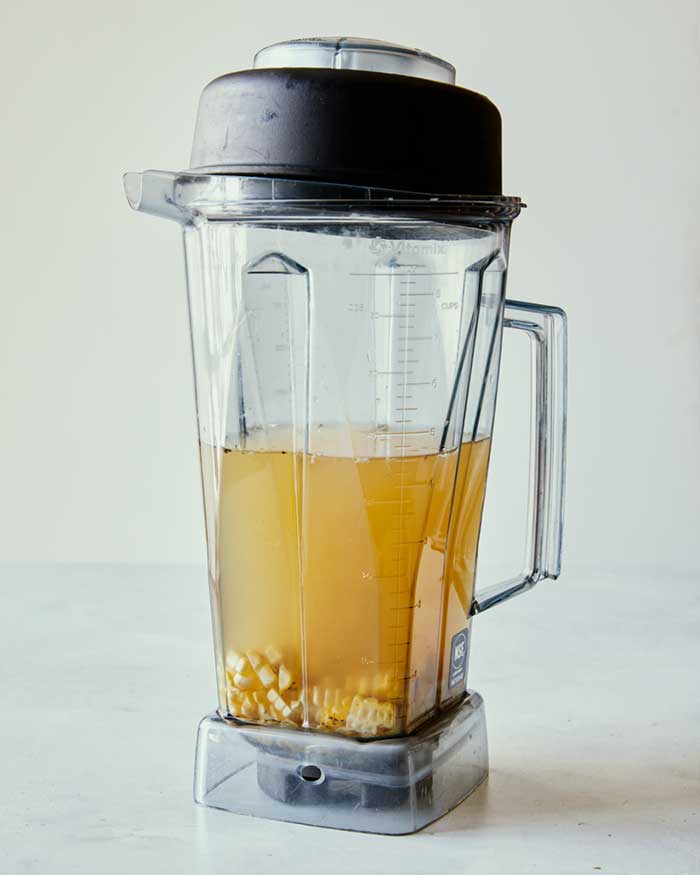 Corn kernels in stock in a blender to be blended.