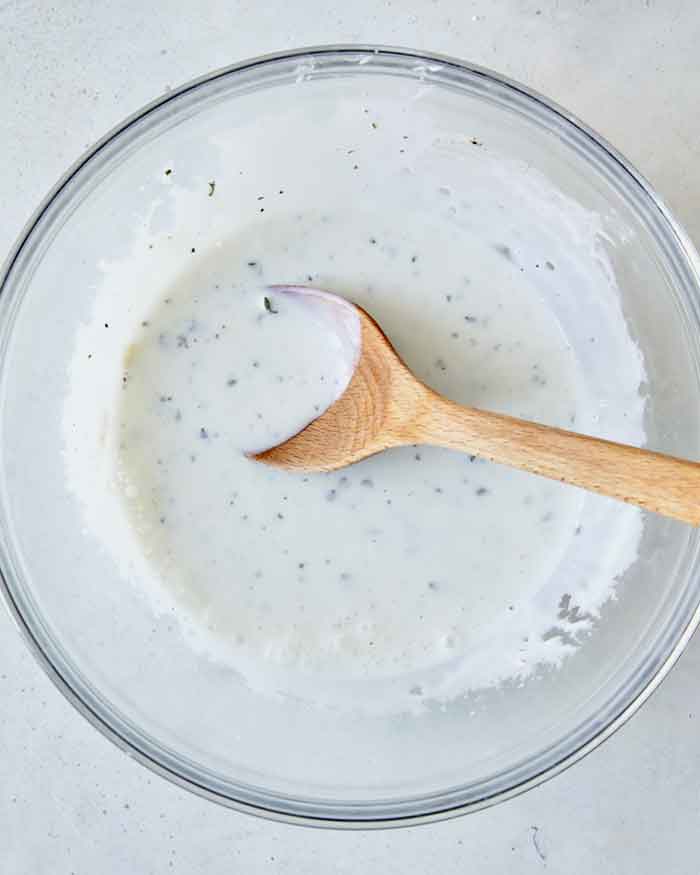 Buttermilk ingredients mixed together in a bowl overhead.
