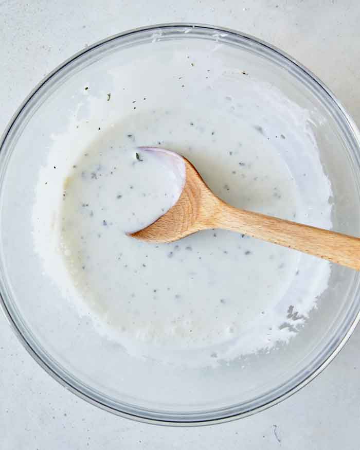 Buttermilk ingredients mixed together in a bowl overhead. 