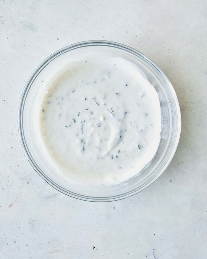 A bowl of buttermilk ranch dipping sauce ingredients all mixed together. 