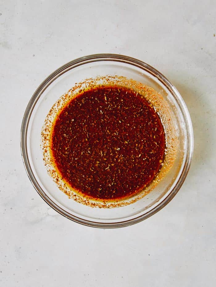 Marinade ingredients in a glass bowl for carne asada.