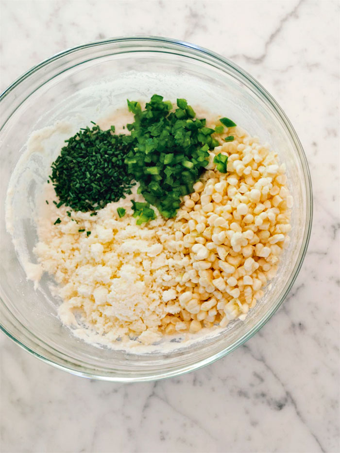 Corn. chives, and jalapeno in the bowl with a the other ingredients.