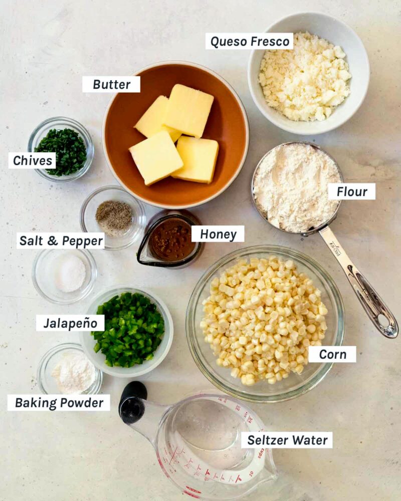Ingredients for corn cakes shot overhead and labeled.