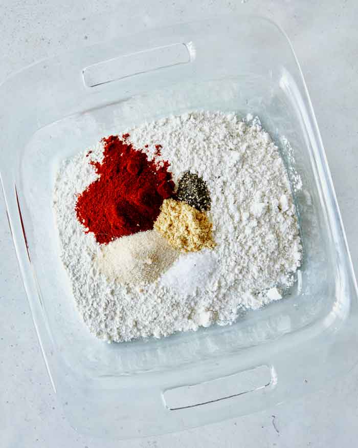 Dredging ingredients in a shallow baking dish overhad.