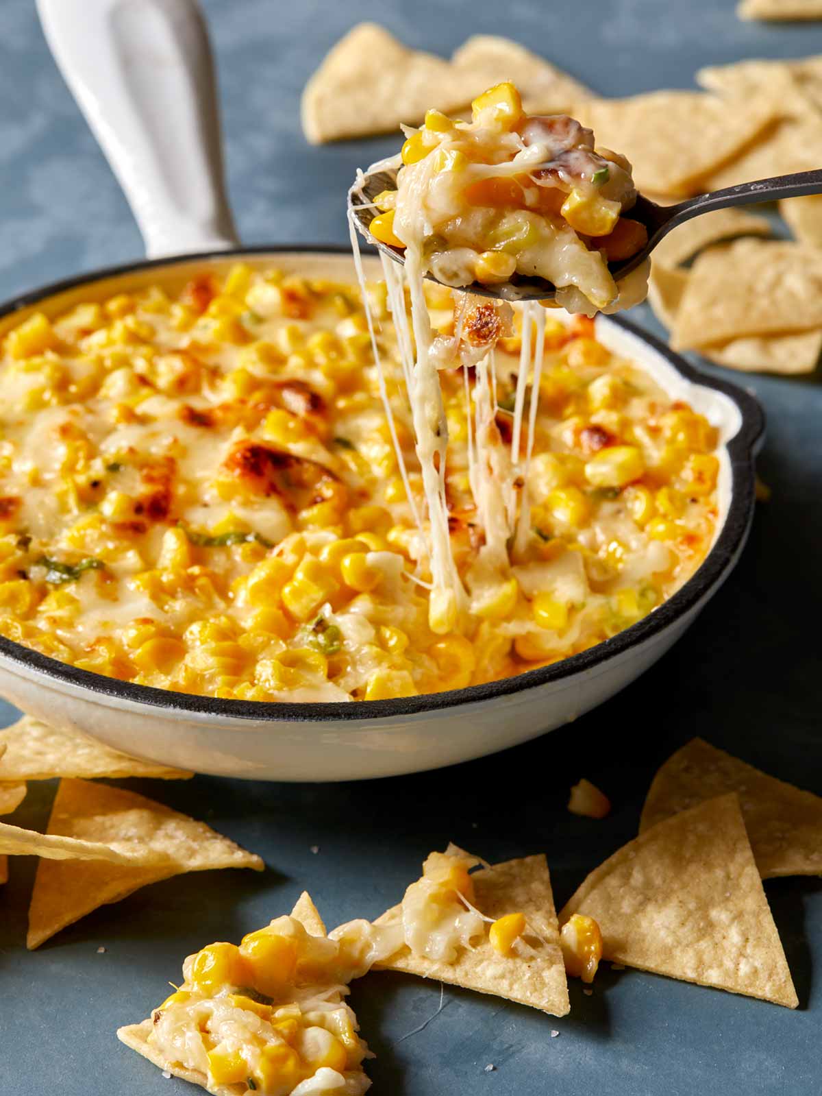 Korean Corn Cheese shot into with a scoop out with cheese pulls.