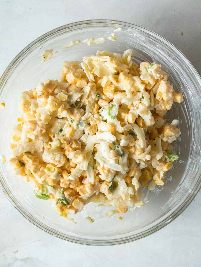 Korean Corn Cheese ingredients in a bowl completely mixed ready to be added to a skillet. 