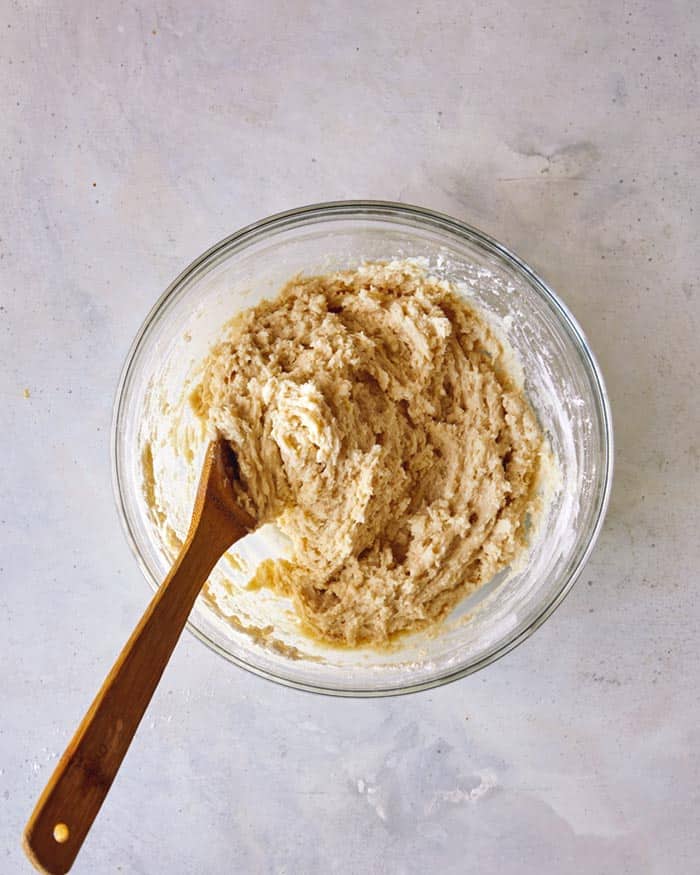 Mixed batter for a cookie dough in a bowl overhead. 