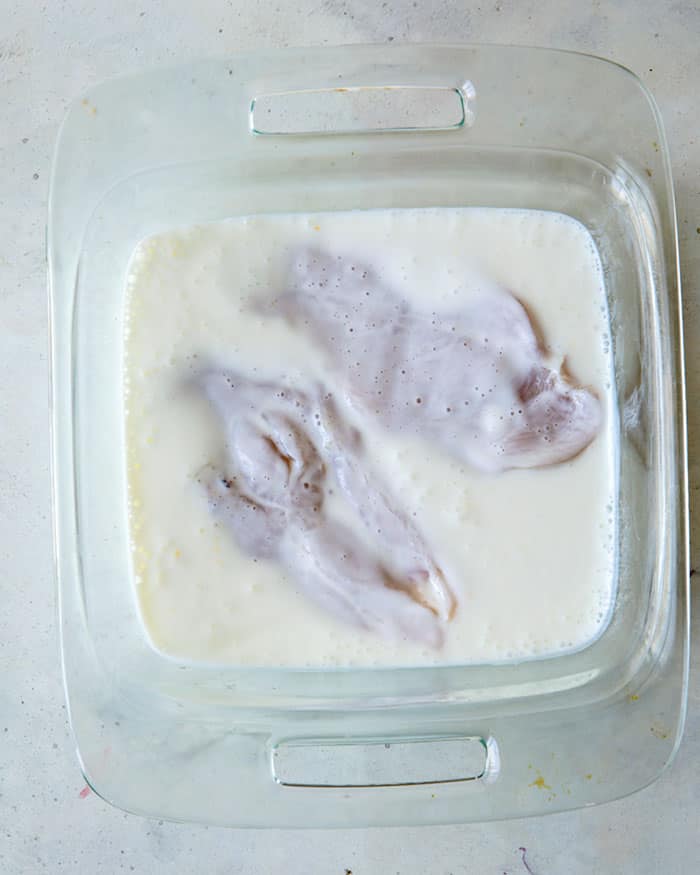 Chicken marinating in buttermilk.