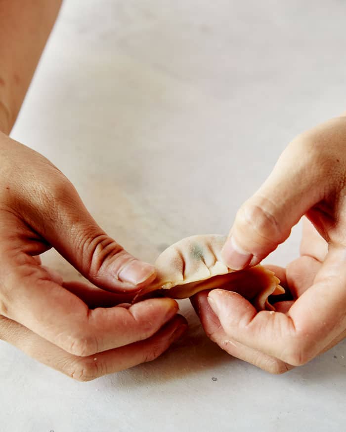 The process of making a potsticker.