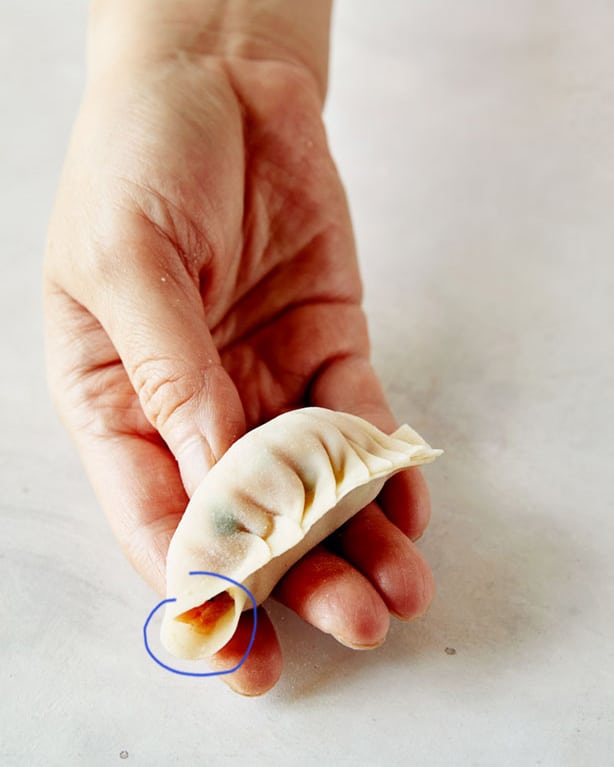 The process of pleating a potsticker.