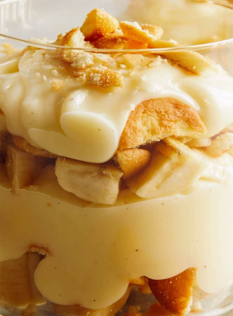 A close up on the side of a glass cup that shows the layers of banana pudding.