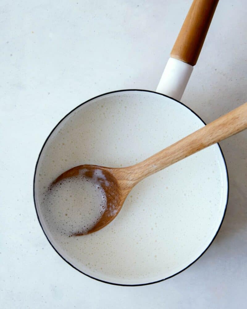 Milk in a pot being warmed up for banana pudding.