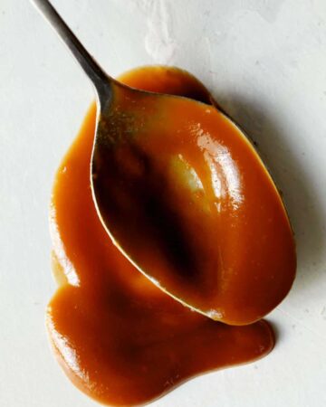 A spoonful of cajeta on a surface.
