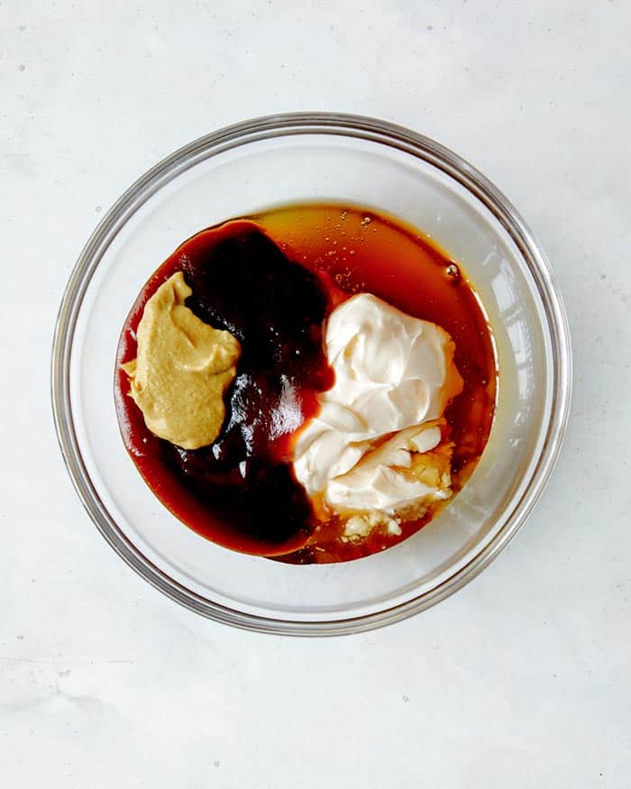 Ingredients for chicl fil sauce in a glass bowl waiting to be mixed together. 