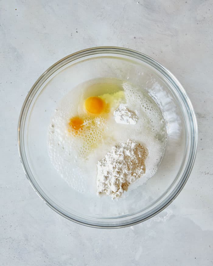 Batter for crispy chicken thighs in a mixing bowl ready to be mixed.