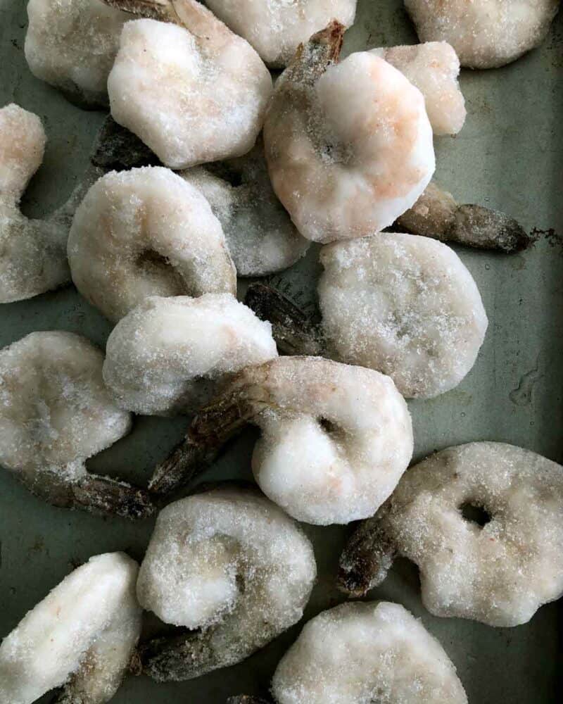 Frozen shrimp on a baking sheet.