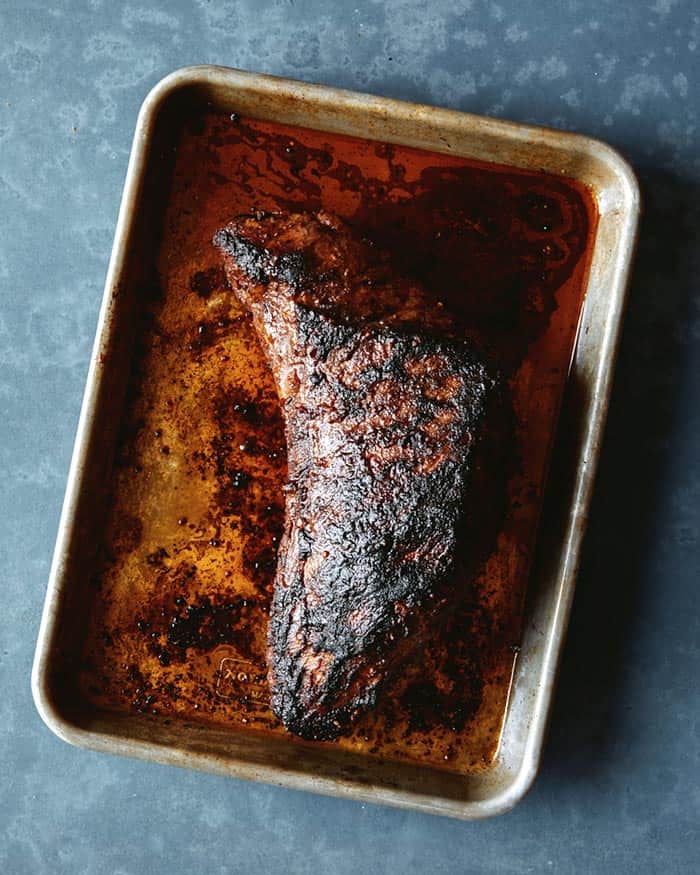 A freshly grilled tri tip which is resting before it is being sliced.
