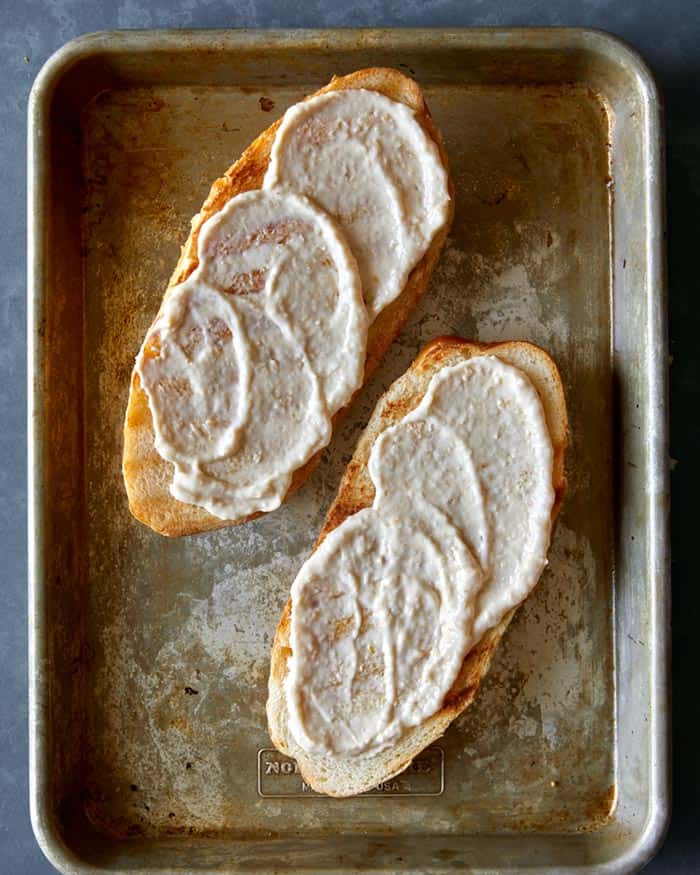 Spread horseradish sauce onto grilled ciabatta rolls.