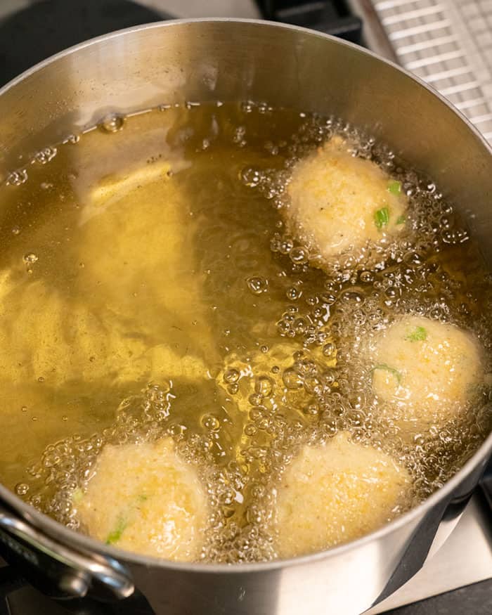 Frying Hush Puppies in a pot with oil.