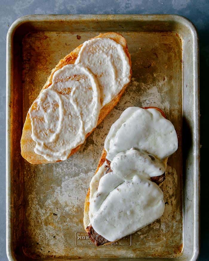 Cheese melted on a tri tip sandwich.