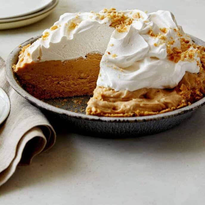 Creamy No Bake Peanut Butter Pie close up with a slice taken out so you can see the inside.