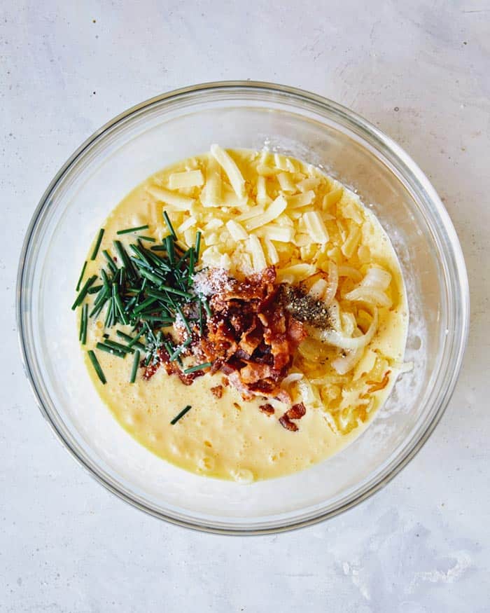 Quiche mixture in a mixing bowl.