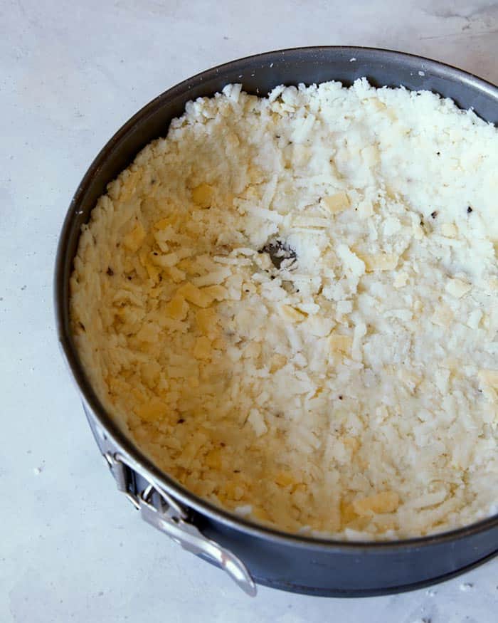 Hash brown crust in a springform pan, close up on the crust.