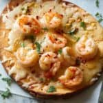 Shrimp Scampi Flatbread on a piece of parchment up close.