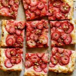 Strawberry tart cut into squares.