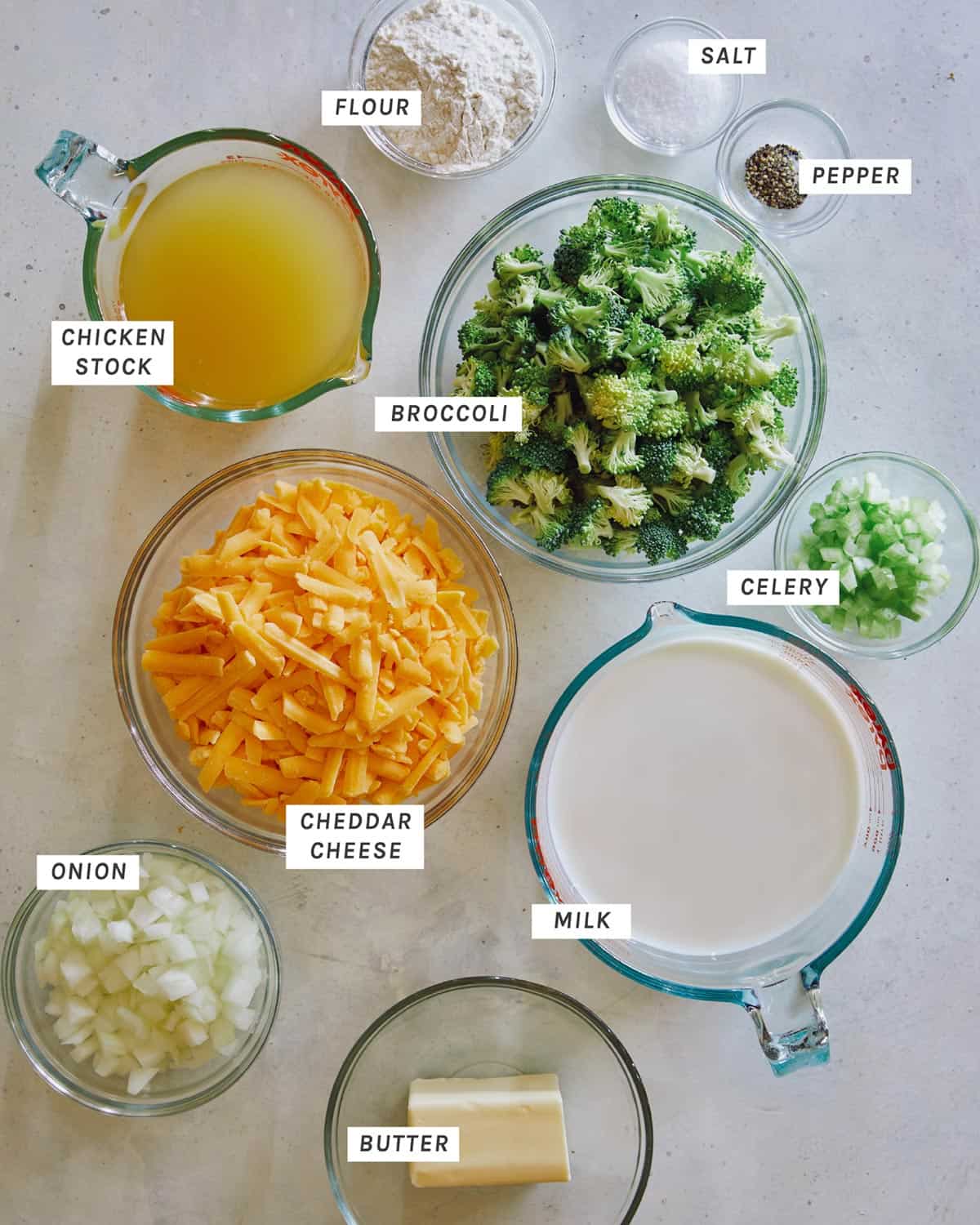 Ingredients for Broccoli Cheddar Soup laid out in bowls. 