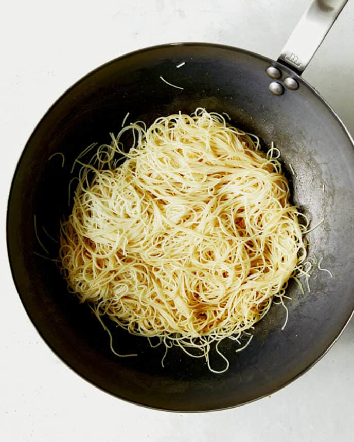 Cook vermicelli noodles in a wok.