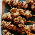 A platter of skewered lamb kabobs on a platter.